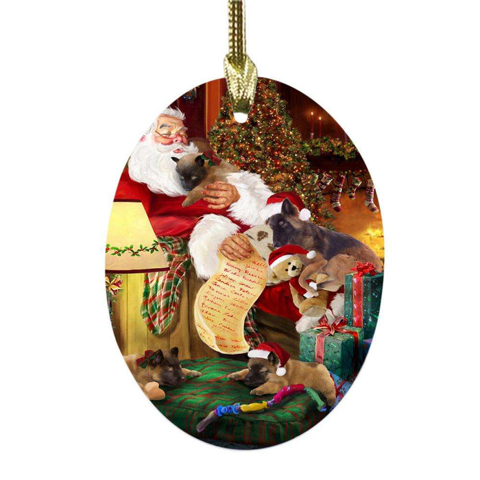 Belgian Tervurens Dog and Puppies Sleeping with Santa Oval Glass Christmas Ornament OGOR49245
