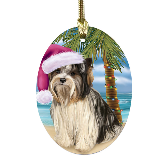 Summertime Happy Holidays Christmas Biewer Dog on Tropical Island Beach Oval Glass Christmas Ornament OGOR49351