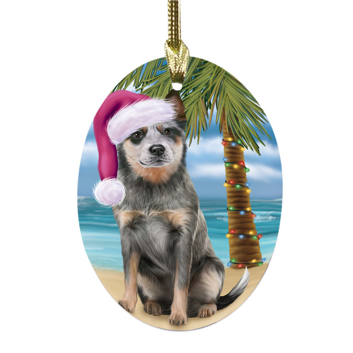 Summertime Happy Holidays Christmas Blue Heeler Dog on Tropical Island Beach Oval Glass Christmas Ornament OGOR49355
