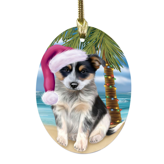 Summertime Happy Holidays Christmas Blue Heeler Dog on Tropical Island Beach Oval Glass Christmas Ornament OGOR49356