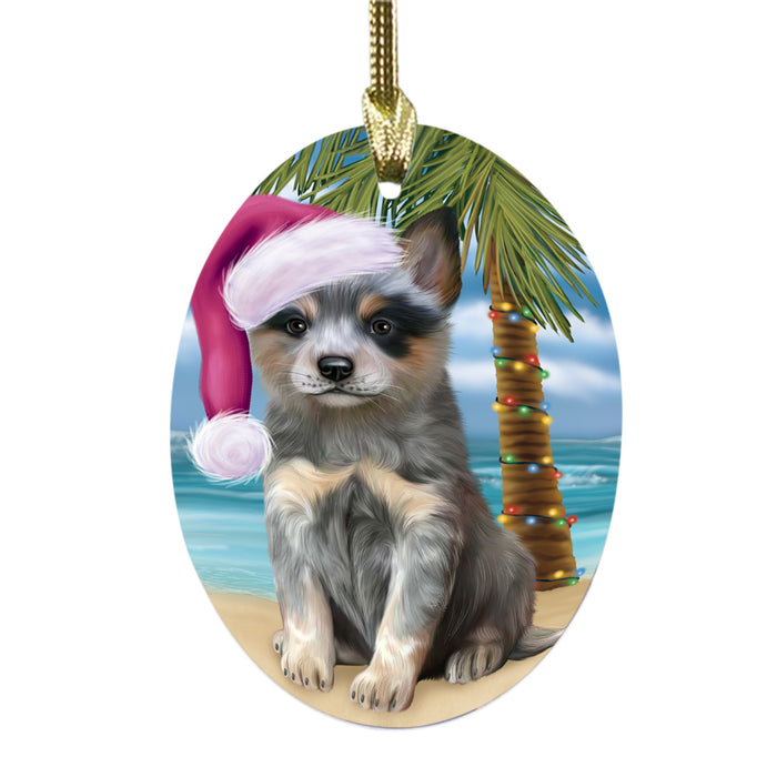 Summertime Happy Holidays Christmas Blue Heeler Dog on Tropical Island Beach Oval Glass Christmas Ornament OGOR49357