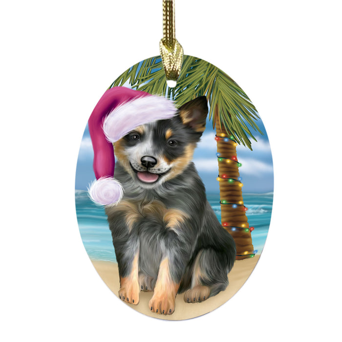 Summertime Happy Holidays Christmas Blue Heeler Dog on Tropical Island Beach Oval Glass Christmas Ornament OGOR49358