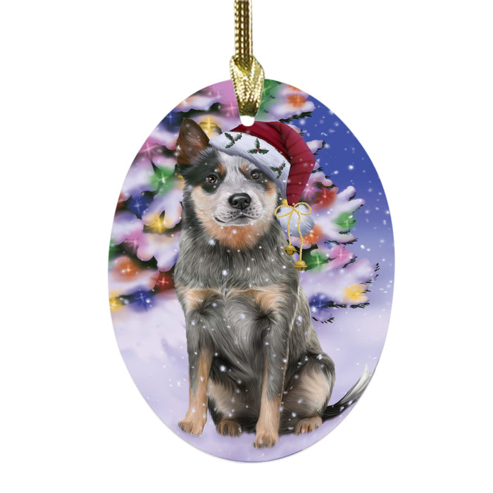 Winterland Wonderland Blue Heeler Dog In Christmas Holiday Scenic Background Oval Glass Christmas Ornament OGOR49526
