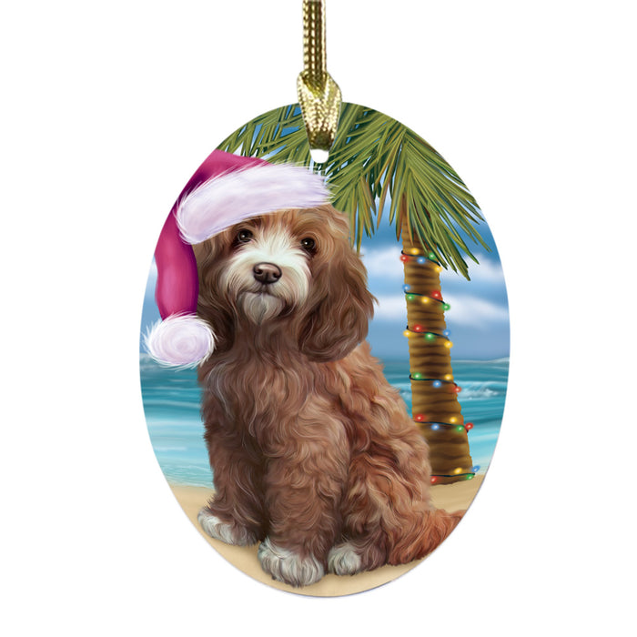 Summertime Happy Holidays Christmas Cockapoo Dog on Tropical Island Beach Oval Glass Christmas Ornament OGOR49359