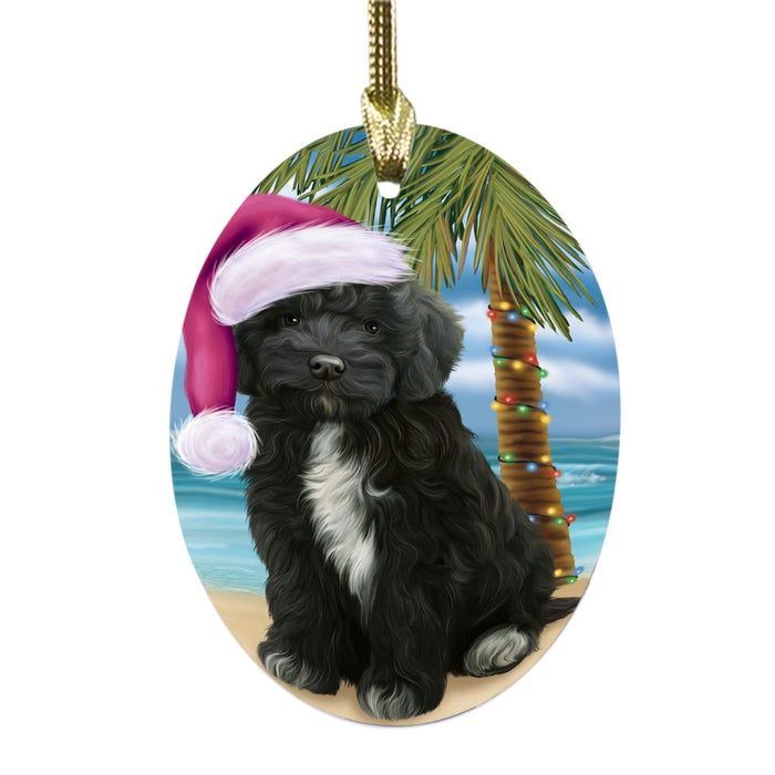 Summertime Happy Holidays Christmas Cockapoo Dog on Tropical Island Beach Oval Glass Christmas Ornament OGOR49360