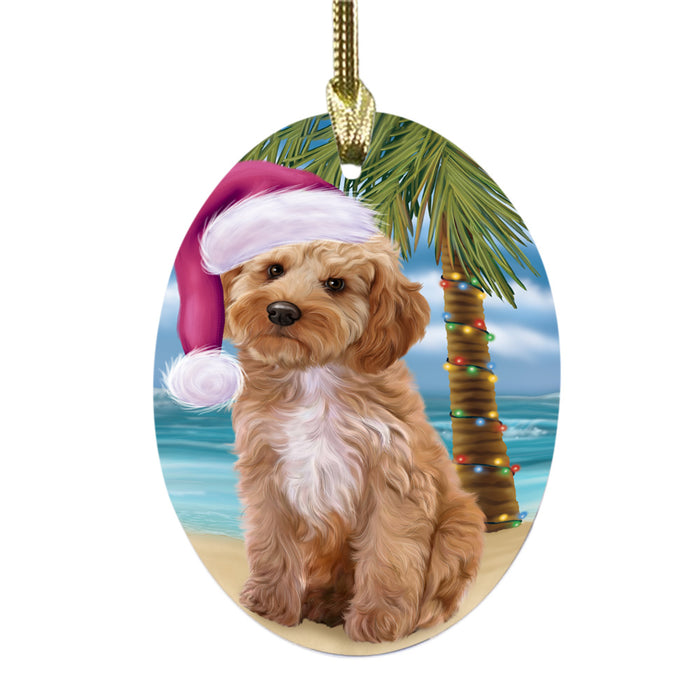 Summertime Happy Holidays Christmas Cockapoo Dog on Tropical Island Beach Oval Glass Christmas Ornament OGOR49361