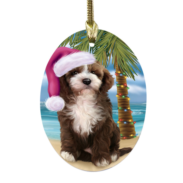 Summertime Happy Holidays Christmas Cockapoo Dog on Tropical Island Beach Oval Glass Christmas Ornament OGOR49362