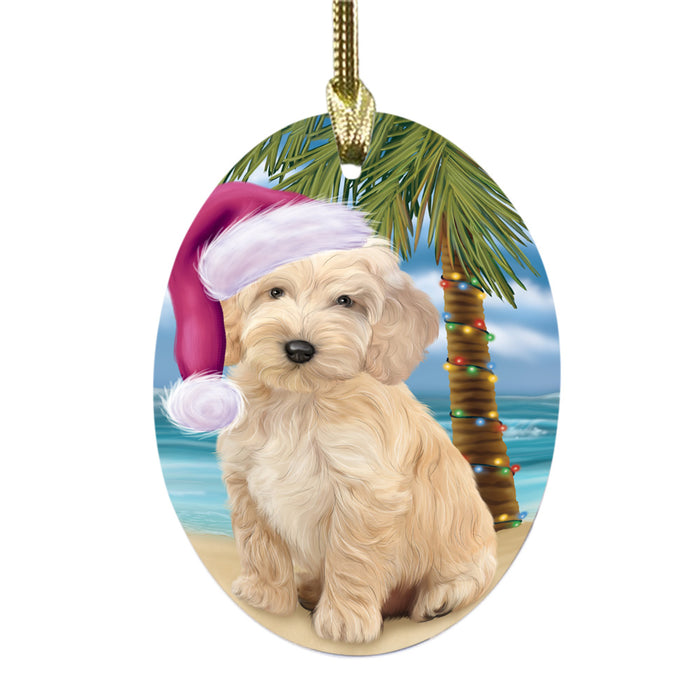 Summertime Happy Holidays Christmas Cockapoo Dog on Tropical Island Beach Oval Glass Christmas Ornament OGOR49363