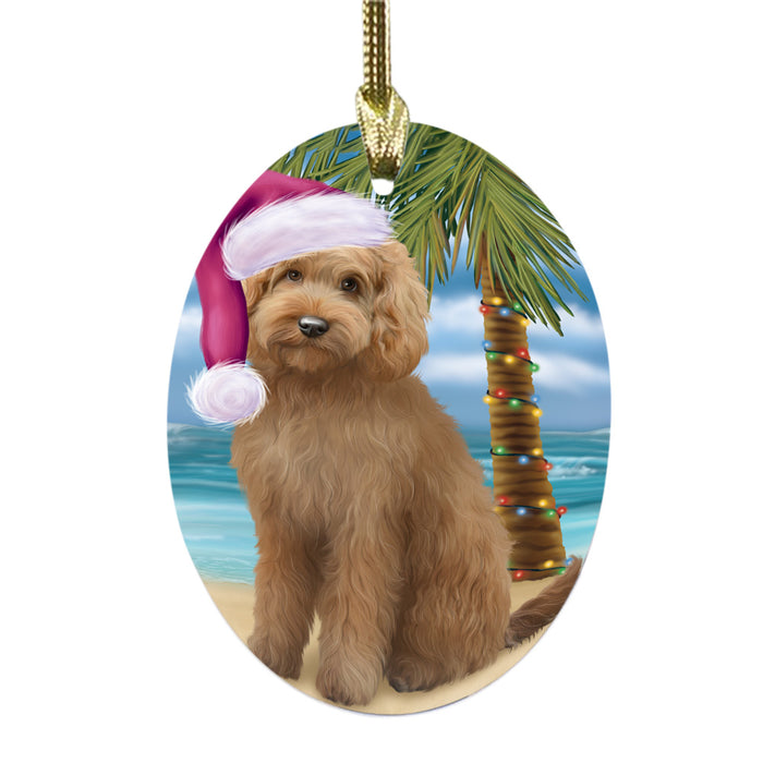 Summertime Happy Holidays Christmas Goldendoodle Dog on Tropical Island Beach Oval Glass Christmas Ornament OGOR49369