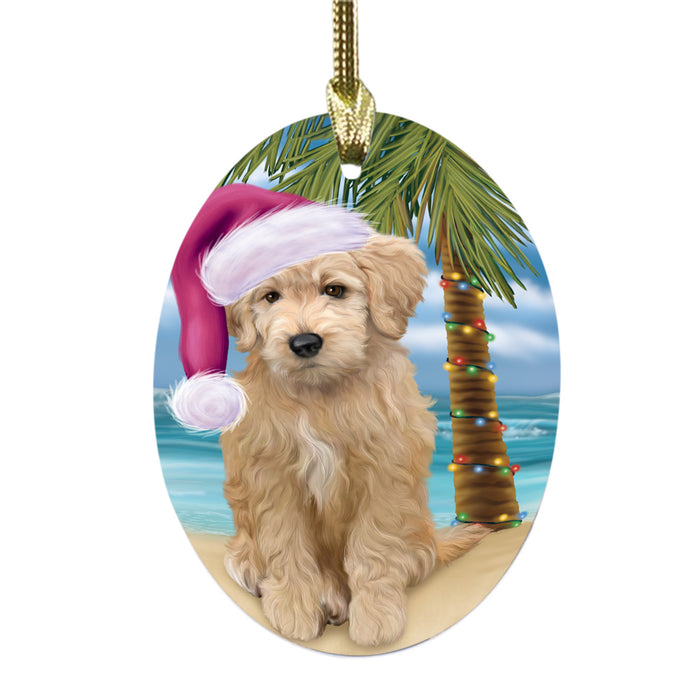 Summertime Happy Holidays Christmas Goldendoodle Dog on Tropical Island Beach Oval Glass Christmas Ornament OGOR49370