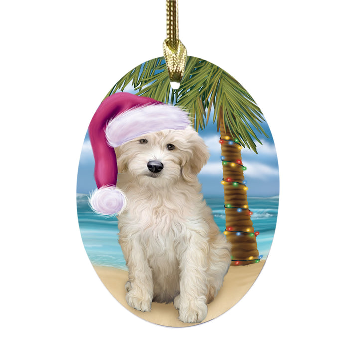 Summertime Happy Holidays Christmas Goldendoodle Dog on Tropical Island Beach Oval Glass Christmas Ornament OGOR49371