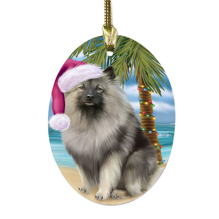 Summertime Happy Holidays Christmas Keeshond Dog on Tropical Island Beach Oval Glass Christmas Ornament OGOR49379