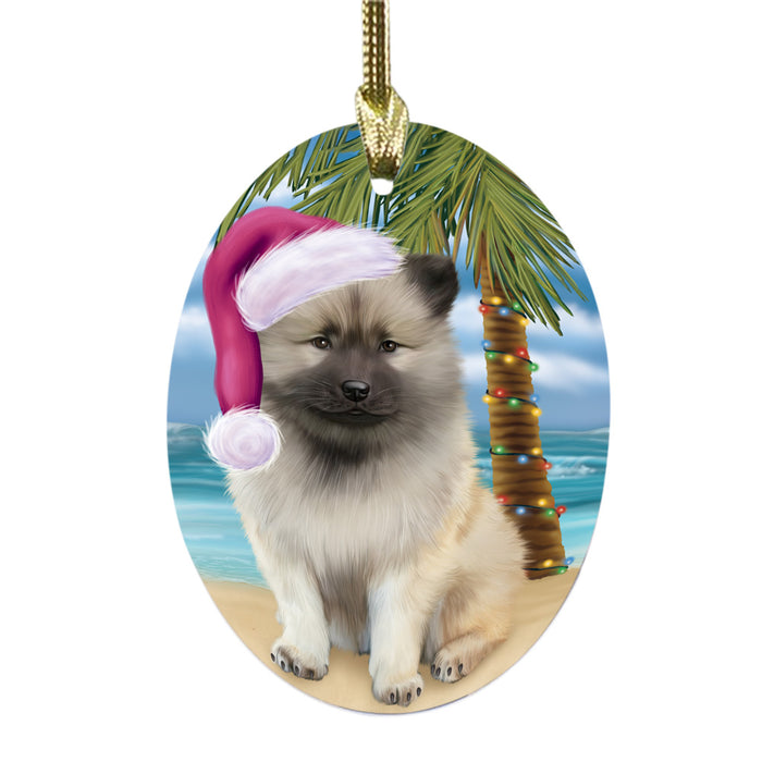 Summertime Happy Holidays Christmas Keeshond Dog on Tropical Island Beach Oval Glass Christmas Ornament OGOR49380