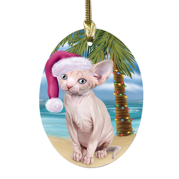 Summertime Happy Holidays Christmas Sphynx Cat on Tropical Island Beach Oval Glass Christmas Ornament OGOR49396