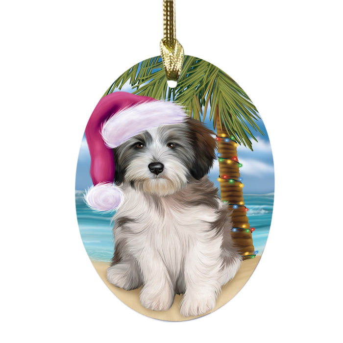 Summertime Happy Holidays Christmas Tibetan Terrier Dog on Tropical Island Beach Oval Glass Christmas Ornament OGOR49400