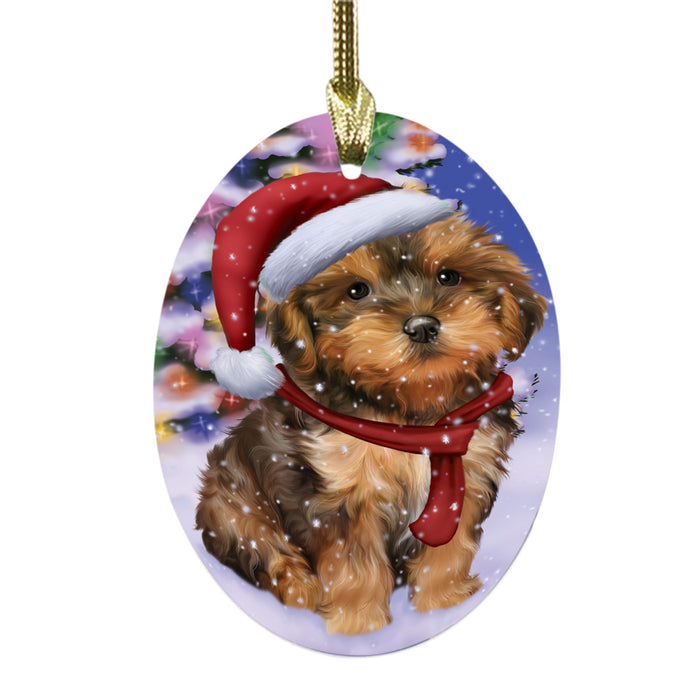 Winterland Wonderland Yorkipoo Dog In Christmas Holiday Scenic Background Oval Glass Christmas Ornament OGOR49665