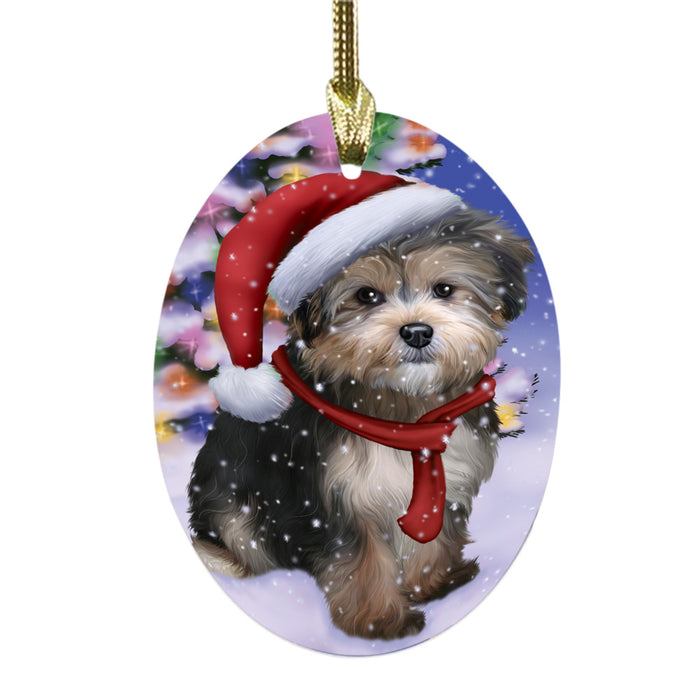 Winterland Wonderland Yorkipoo Dog In Christmas Holiday Scenic Background Oval Glass Christmas Ornament OGOR49667