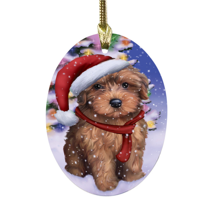 Winterland Wonderland Yorkipoo Dog In Christmas Holiday Scenic Background Oval Glass Christmas Ornament OGOR49668