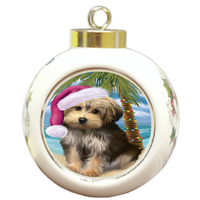 Summertime Happy Holidays Christmas Yorkipoo Dog on Tropical Island Beach Round Ball Christmas Ornament RBPOR54600