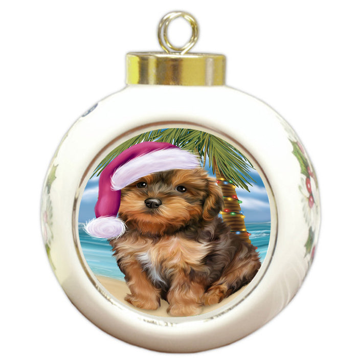 Summertime Happy Holidays Christmas Yorkipoo Dog on Tropical Island Beach Round Ball Christmas Ornament RBPOR54601
