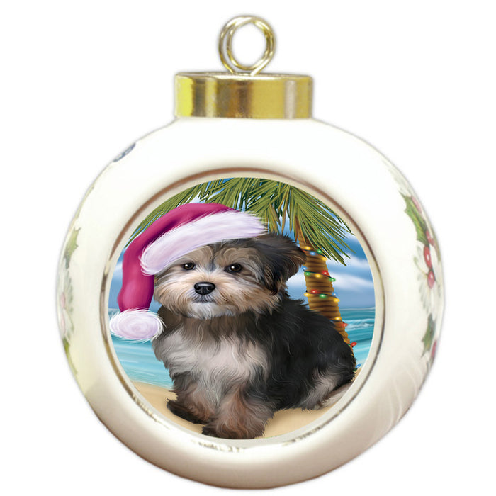 Summertime Happy Holidays Christmas Yorkipoo Dog on Tropical Island Beach Round Ball Christmas Ornament RBPOR54603