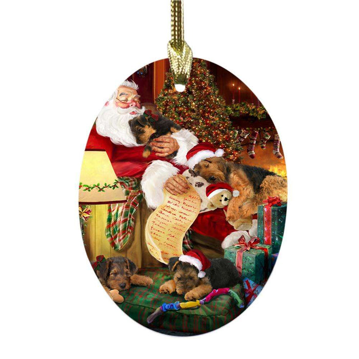 Airedales Dog and Puppies Sleeping with Santa Oval Glass Christmas Ornament OGOR49232