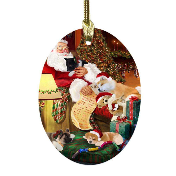 Akitas Dog and Puppies Sleeping with Santa Oval Glass Christmas Ornament OGOR49233