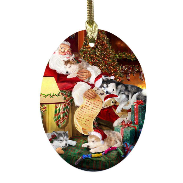 Alaskan Malamutes Dog and Puppies Sleeping with Santa Oval Glass Christmas Ornament OGOR49234