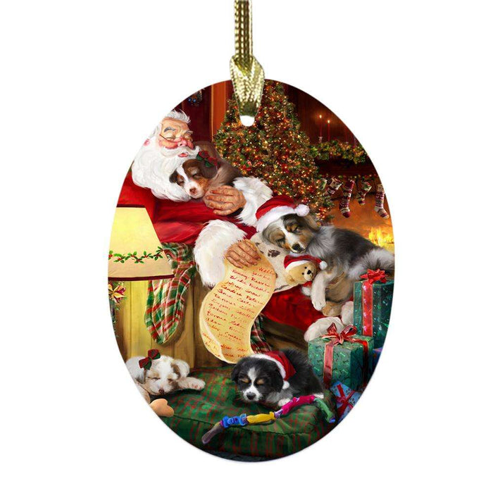 Australian Shepherds Dog and Puppies Sleeping with Santa Oval Glass Christmas Ornament OGOR49242