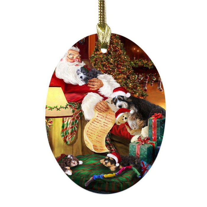 Bernedoodles Dog and Puppies Sleeping with Santa Oval Glass Christmas Ornament OGOR49247