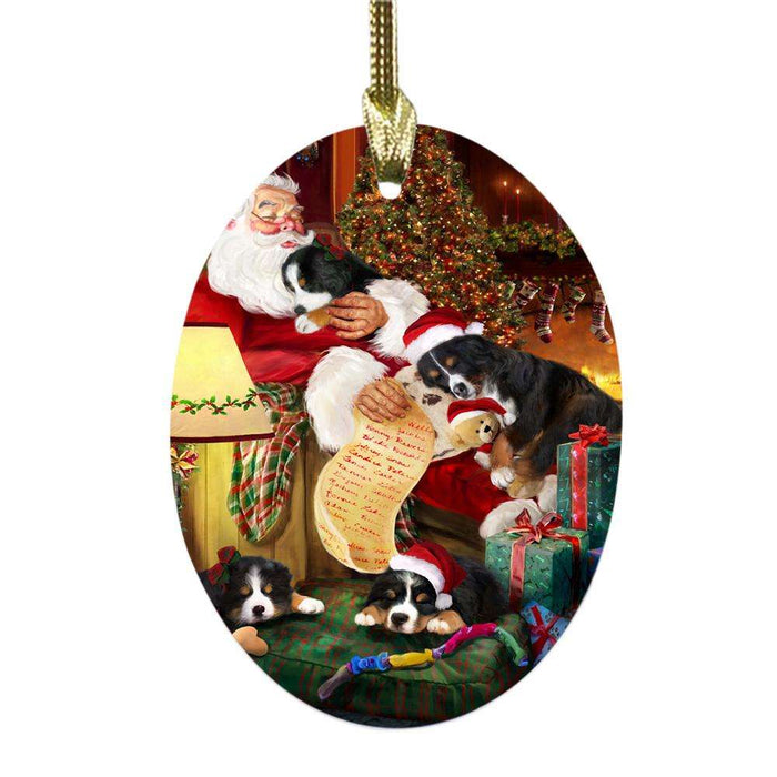 Bernese Mountain Dogs and Puppies Sleeping with Santa Oval Glass Christmas Ornament OGOR49248