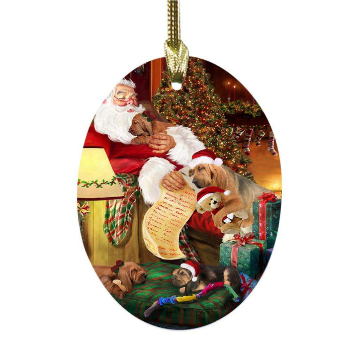 Bloodhounds Dog and Puppies Sleeping with Santa Oval Glass Christmas Ornament OGOR49252