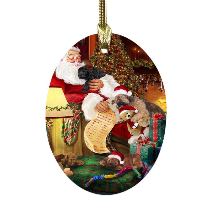 Briards Dog and Puppies Sleeping with Santa Oval Glass Christmas Ornament OGOR49260