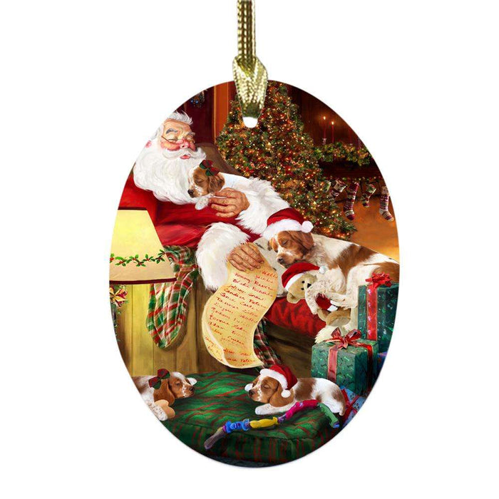 Brittany Spaniels Dog and Puppies Sleeping with Santa Oval Glass Christmas Ornament OGOR49262