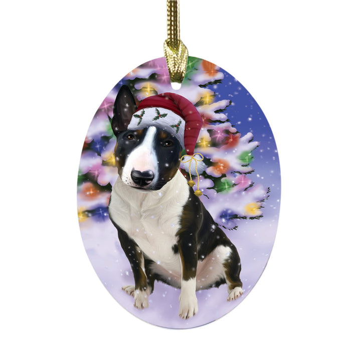 Winterland Wonderland Bull Terrier Dog In Christmas Holiday Scenic Background Oval Glass Christmas Ornament OGOR49540