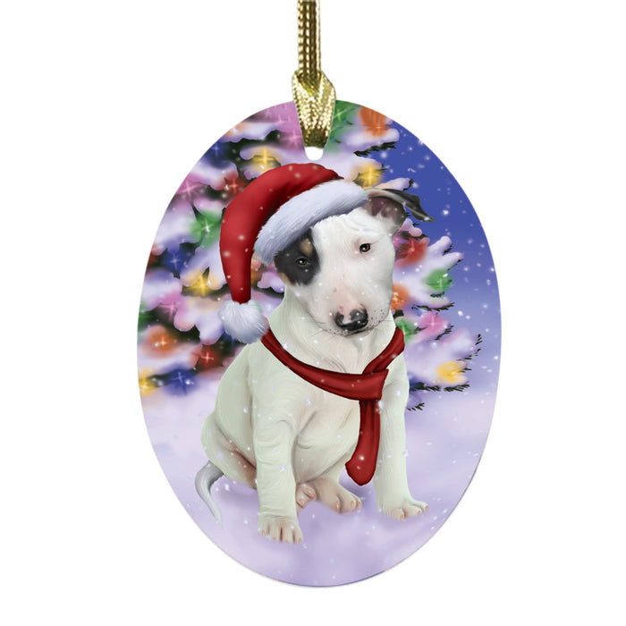 Winterland Wonderland Bull Terrier Dog In Christmas Holiday Scenic Background Oval Glass Christmas Ornament OGOR49541