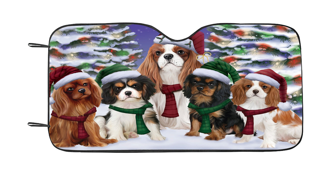 Cavalier King Charles Spaniel Dogs Christmas Family Portrait in Holiday Scenic Background Car Sun Shade