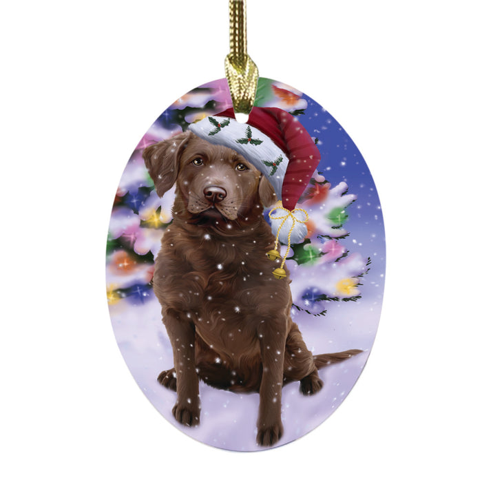 Winterland Wonderland Chesapeake Bay Retriever Dog In Christmas Holiday Scenic Background Oval Glass Christmas Ornament OGOR49550