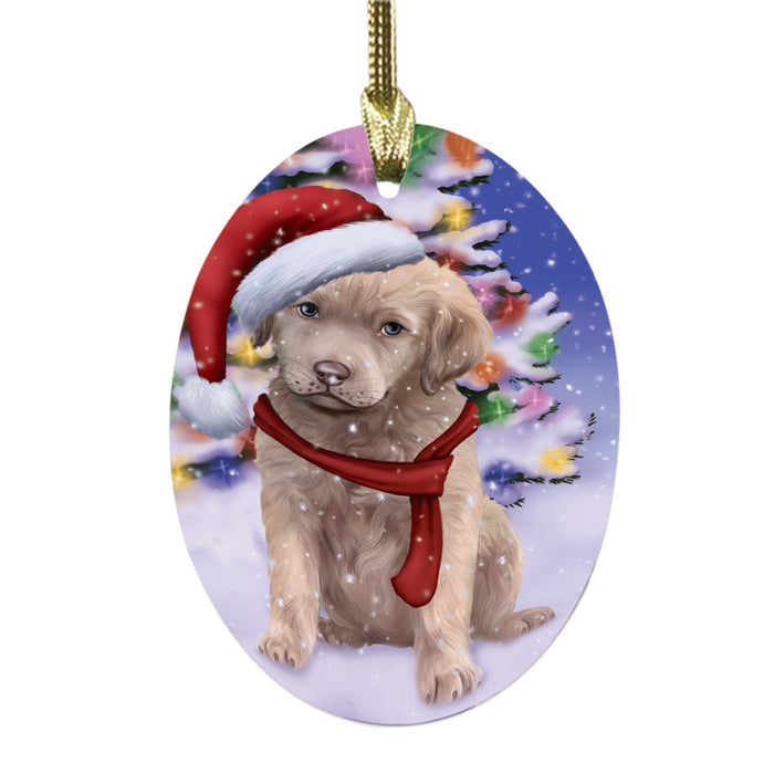 Winterland Wonderland Chesapeake Bay Retriever Dog In Christmas Holiday Scenic Background Oval Glass Christmas Ornament OGOR49551