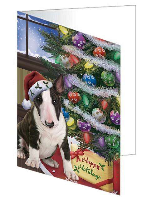 Christmas Happy Holidays Bull Terrier Dog with Tree and Presents Handmade Artwork Assorted Pets Greeting Cards and Note Cards with Envelopes for All Occasions and Holiday Seasons GCD65453
