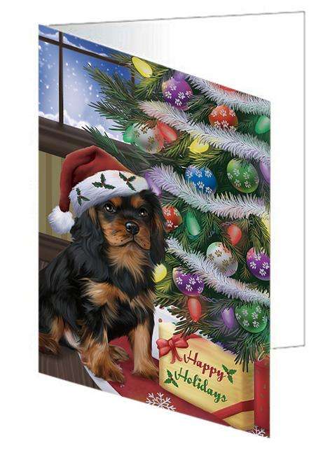 Christmas Happy Holidays Cavalier King Charles Spaniel Dog with Tree and Presents Handmade Artwork Assorted Pets Greeting Cards and Note Cards with Envelopes for All Occasions and Holiday Seasons GCD65471