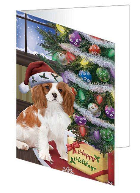 Christmas Happy Holidays Cavalier King Charles Spaniel Dog with Tree and Presents Handmade Artwork Assorted Pets Greeting Cards and Note Cards with Envelopes for All Occasions and Holiday Seasons GCD65477