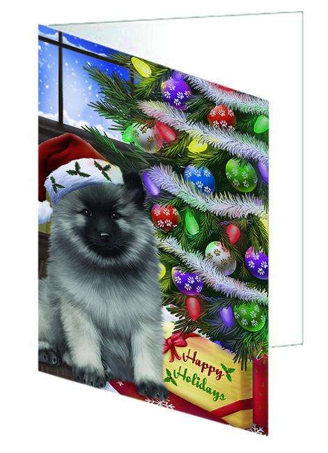 Christmas Happy Holidays Keeshond Dog with Tree and Presents Handmade Artwork Assorted Pets Greeting Cards and Note Cards with Envelopes for All Occasions and Holiday Seasons GCD64415