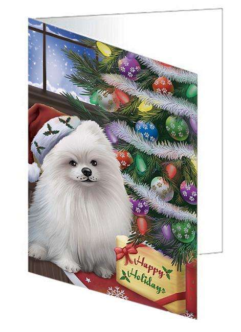 Christmas Happy Holidays Pomeranian Dog with Tree and Presents Handmade Artwork Assorted Pets Greeting Cards and Note Cards with Envelopes for All Occasions and Holiday Seasons GCD65570