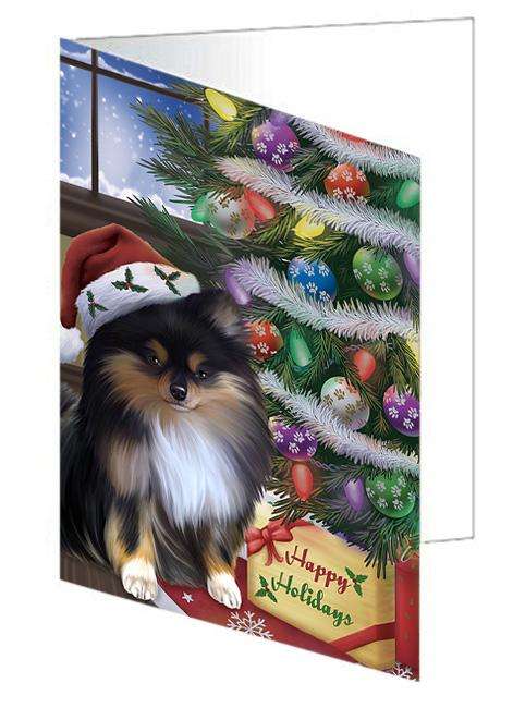 Christmas Happy Holidays Pomeranian Dog with Tree and Presents Handmade Artwork Assorted Pets Greeting Cards and Note Cards with Envelopes for All Occasions and Holiday Seasons GCD65573