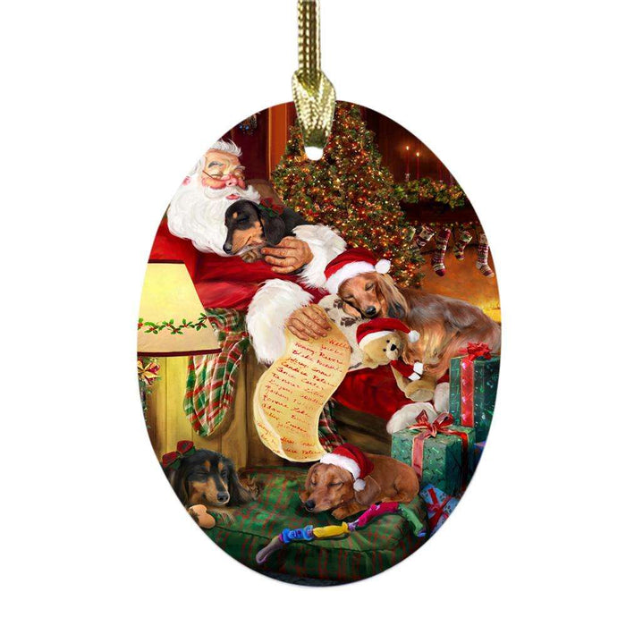 Dachshunds Dog and Puppies Sleeping with Santa Oval Glass Christmas Ornament OGOR49275