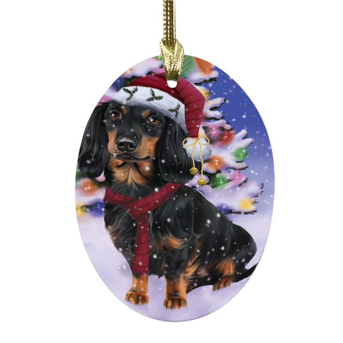 Winterland Wonderland Dachshund Dog In Christmas Holiday Scenic Background Oval Glass Christmas Ornament OGOR49568