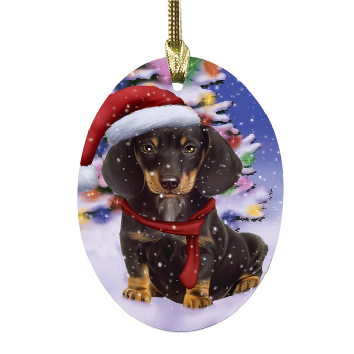 Winterland Wonderland Dachshund Dog In Christmas Holiday Scenic Background Oval Glass Christmas Ornament OGOR49569