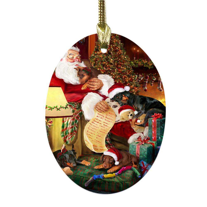 Doberman Pinschers Dog and Puppies Sleeping with Santa Oval Glass Christmas Ornament OGOR49277