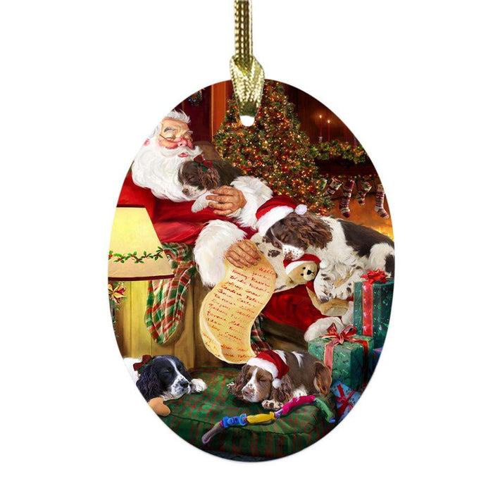English Springer Spaniels Dog and Puppies Sleeping with Santa Oval Glass Christmas Ornament OGOR49278